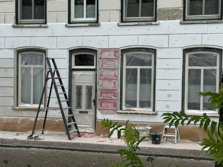 Tijdens: Kozijnen afgeplakt, klaar voor de afwerklaag.